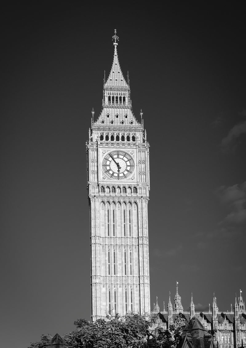 Close-up black and white fine art print of Big Ben — Elizabeth Tower — with intricate Gothic stonework and clock face detail against a deep charcoal sky, London