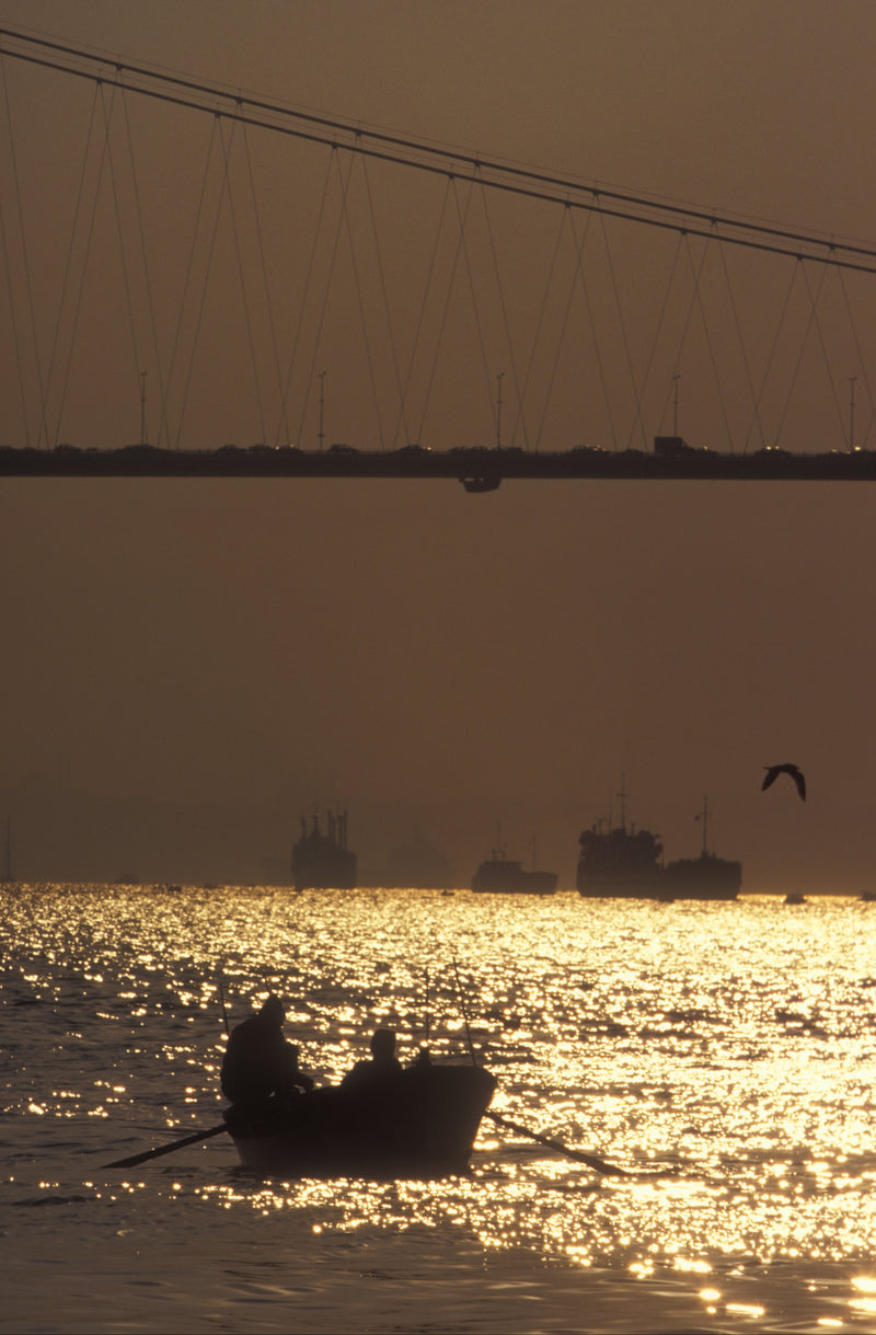 Silhouette of two fishermen in a rowing boat on the Bosphorus at golden hour, with the Bosphorus Bridge overhead, Istanbul fine art print