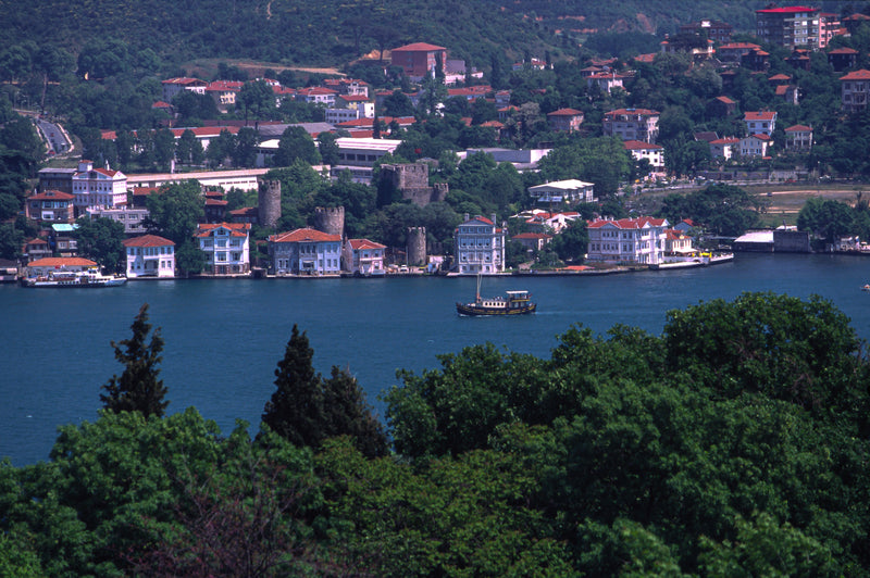Traditional Ottoman yalı mansions with terracotta rooftops along the Anatolian shore of the Bosphorus, with a wooden vessel and ancient stone tower, Istanbul fine art print