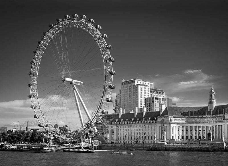 London Eye Ferris wheel with County Hall's grand Edwardian facade on the South Bank and the Thames in the foreground, high contrast black and white fine art photography print