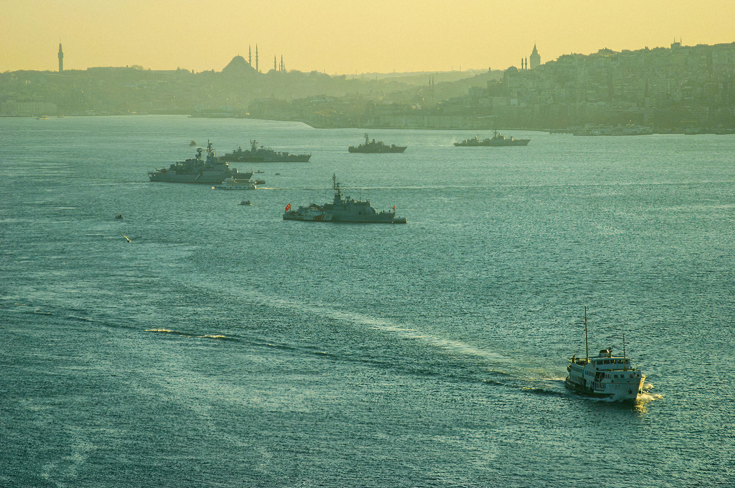A lone vessel crossing a hazy Bosphorus with Istanbul's misty skyline of minarets and rooftops dissolving in the distance, fine art photography print
